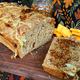 Beer bread with onions, mustard, and cheese on wooden cutting board